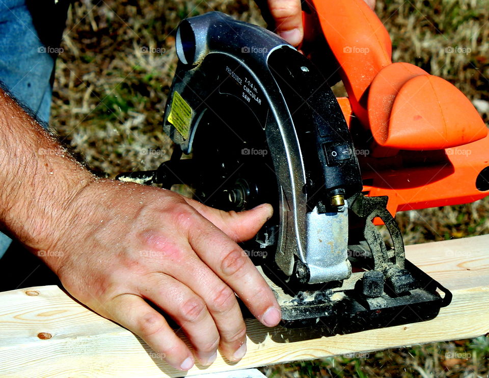 A person sawing wood