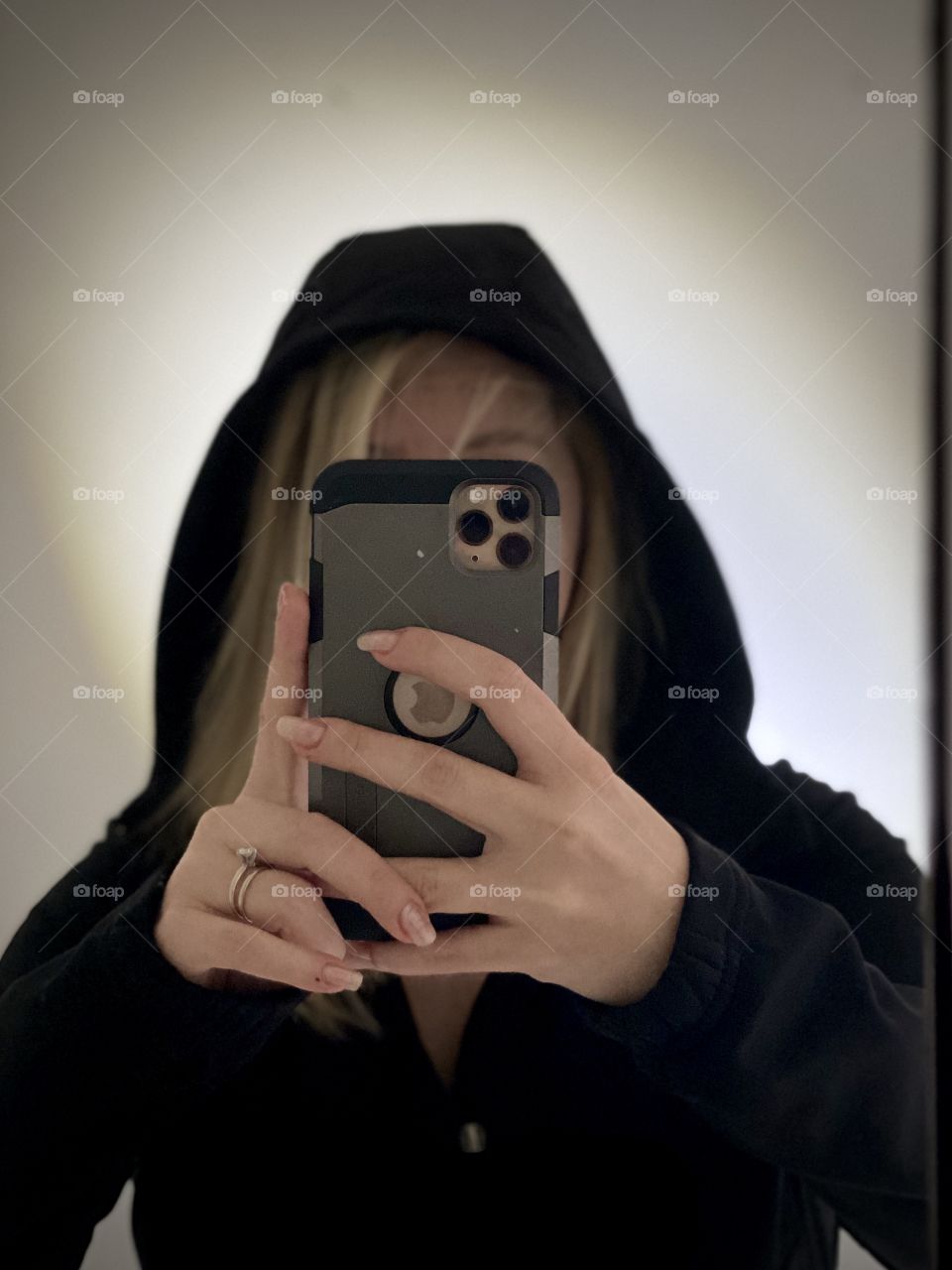 Iphone 11 pro max Selfie in a bathroom, backlight, woman in a black jacket 