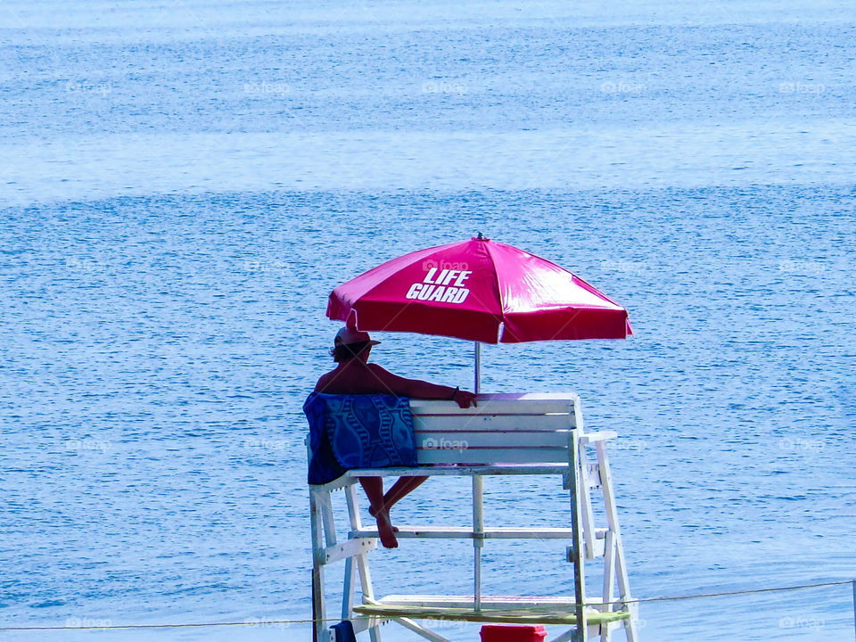 Lifeguard Relaxing By The Ocean