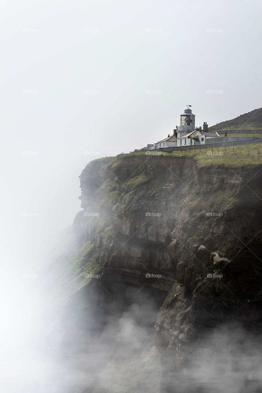 Whitby lighthouse. With the fog rolling in, it looks like it's perched on the edge of the world.