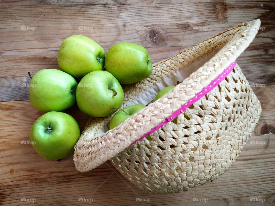 Green apples and straw hat