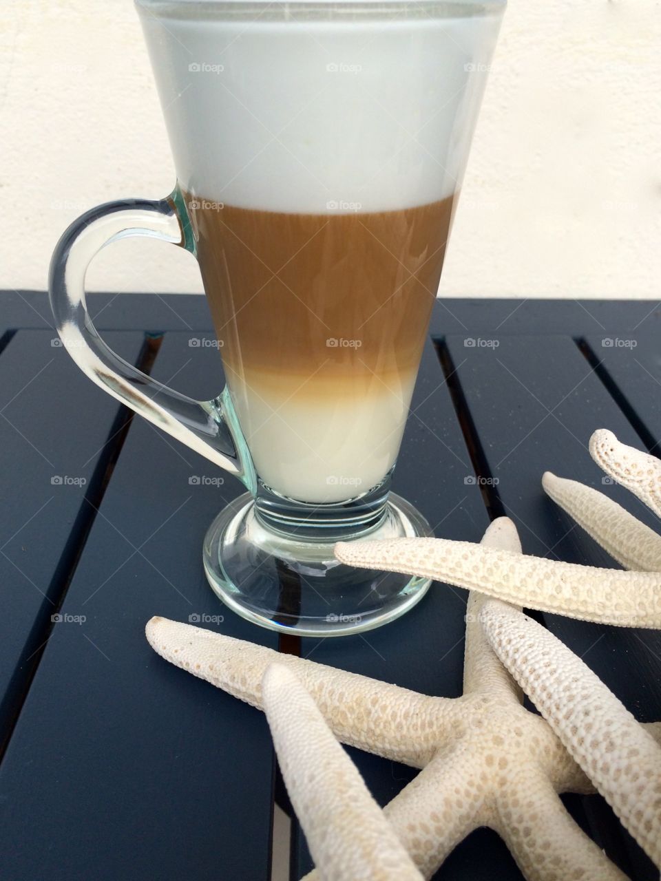 Cappuccino . Cappuccino on table with star fish 