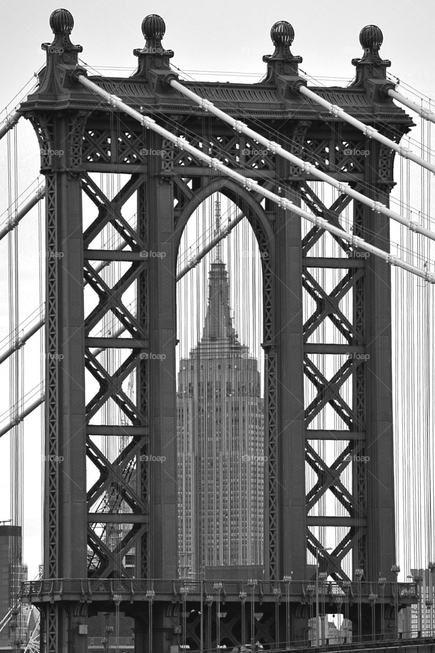 Empire State Building. this is a photo of the Empire State Building looking through the Manhattan Bridge