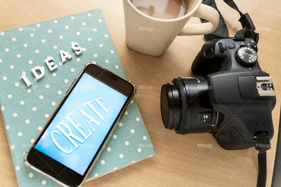 Ideas & create, top view of camera, coffee & notepad