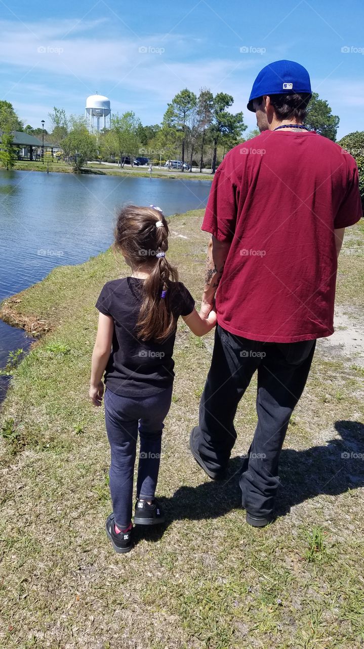 daddy and daughter walk in the park