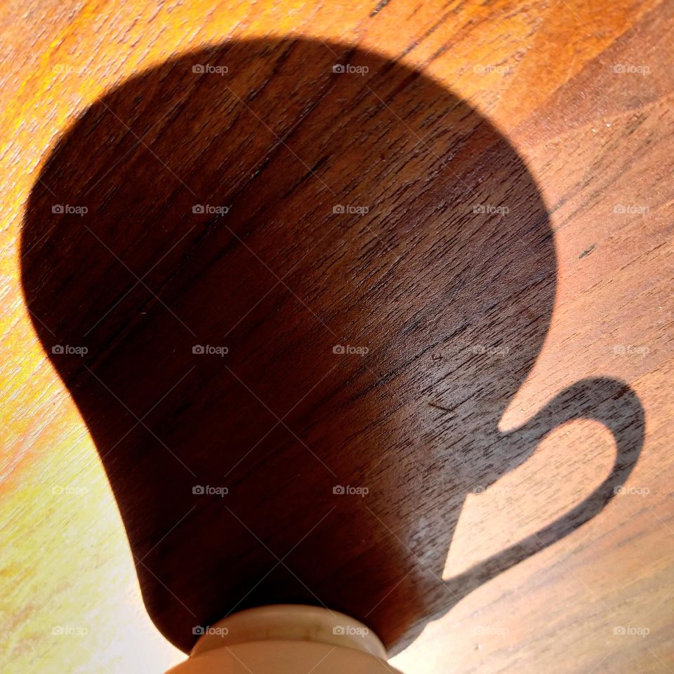 shadow cup of coffee in the morning sunshine