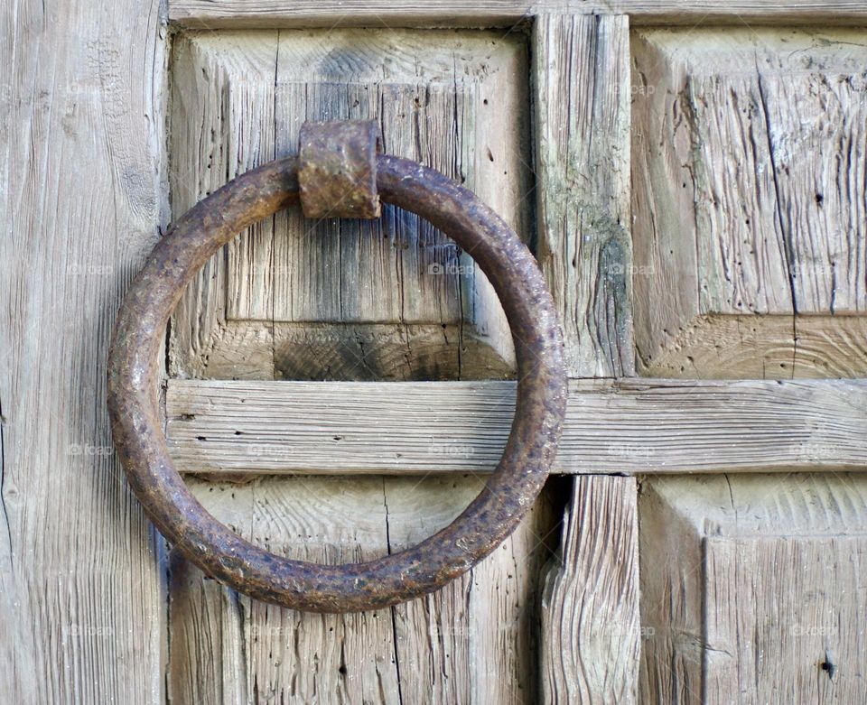 A rusted steel door handle.