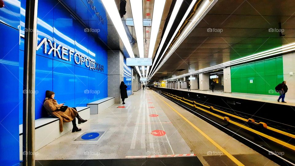 Modern new subway station platform architecture in Moscow in December with people