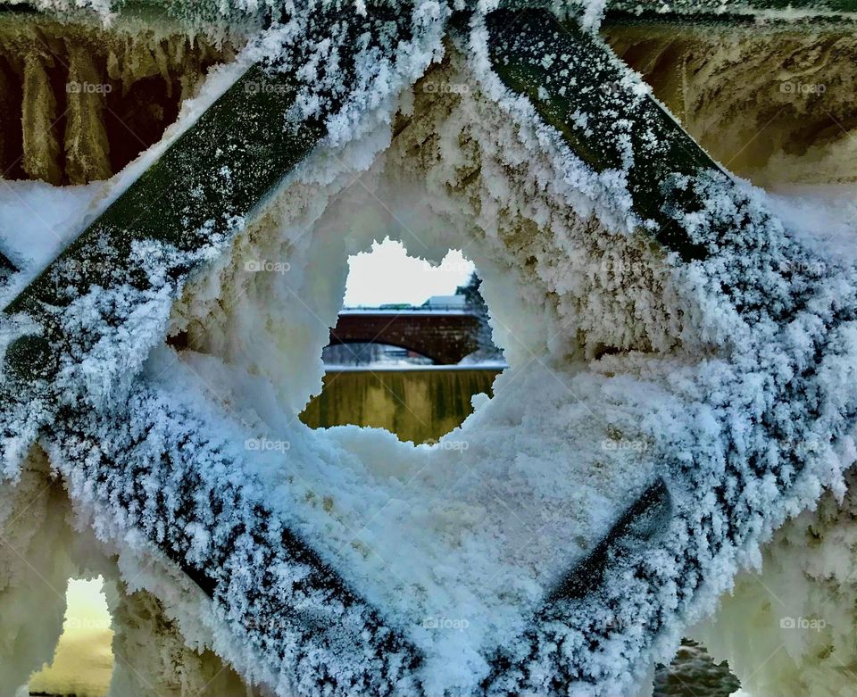 Peak from frozen hole in bridge, Vanhankaupunginkoski, Old town Helsinki, Finland