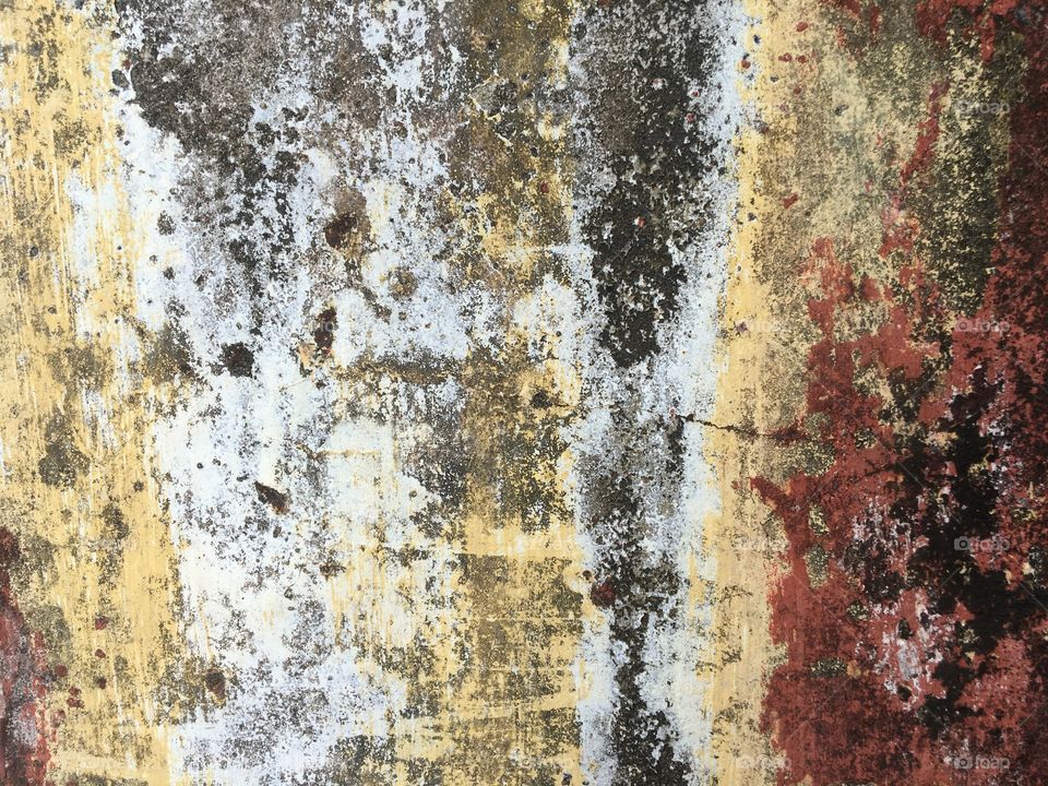 Texture and colours of an old worn cement wall.