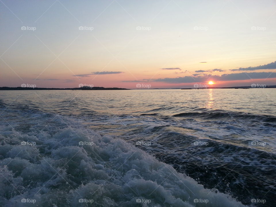 Waves in sea at sunset