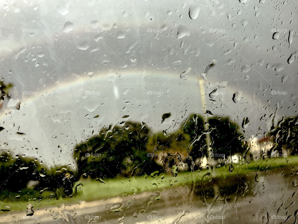 A faint rainbow through the rain. 