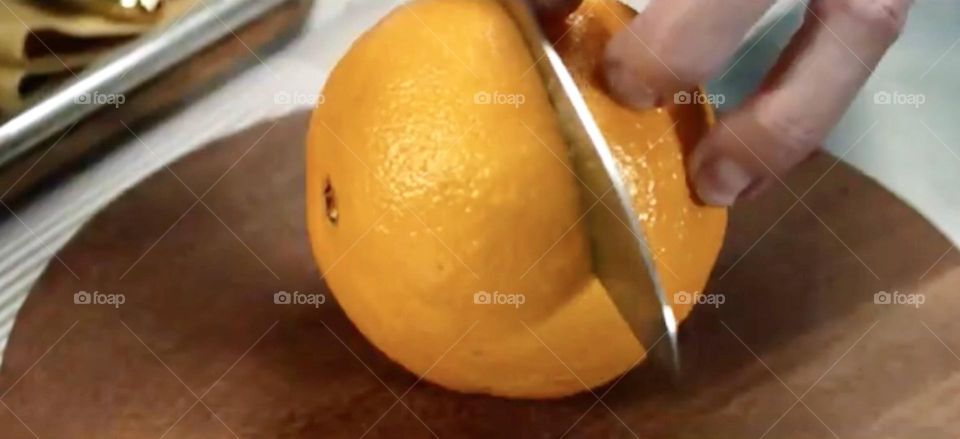 hand cutting orange