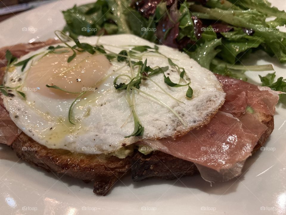 Avocado toast with prosciutto and egg