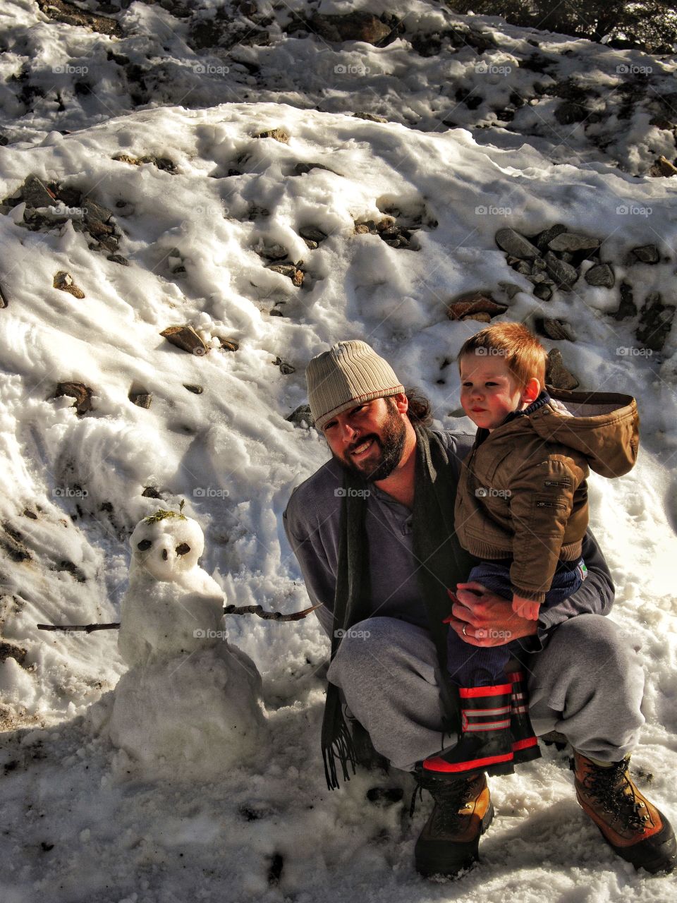 Father And Son Building A Snowman
