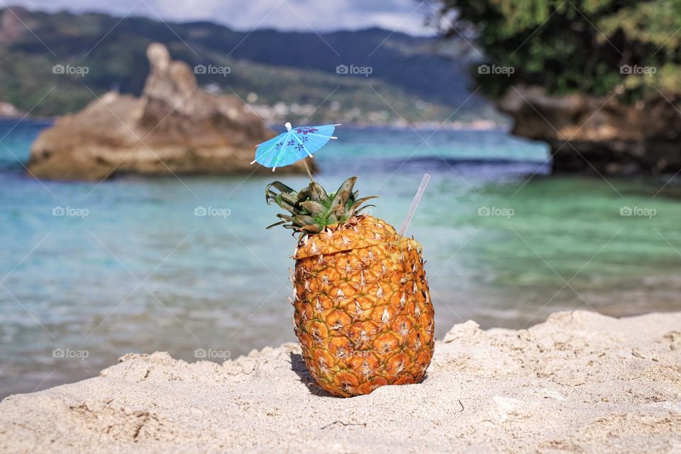 Pina colada in pineapple on the beach 