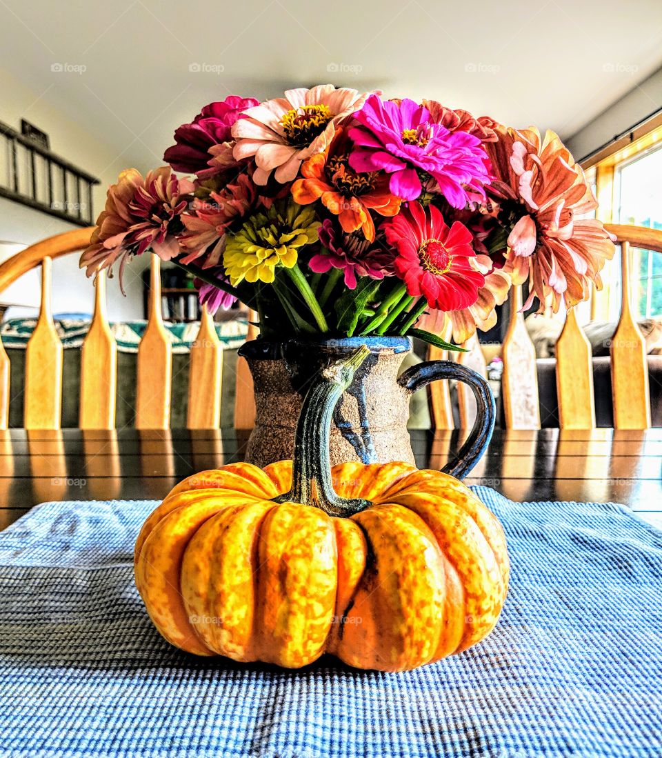 pumpkin with vase of flowers