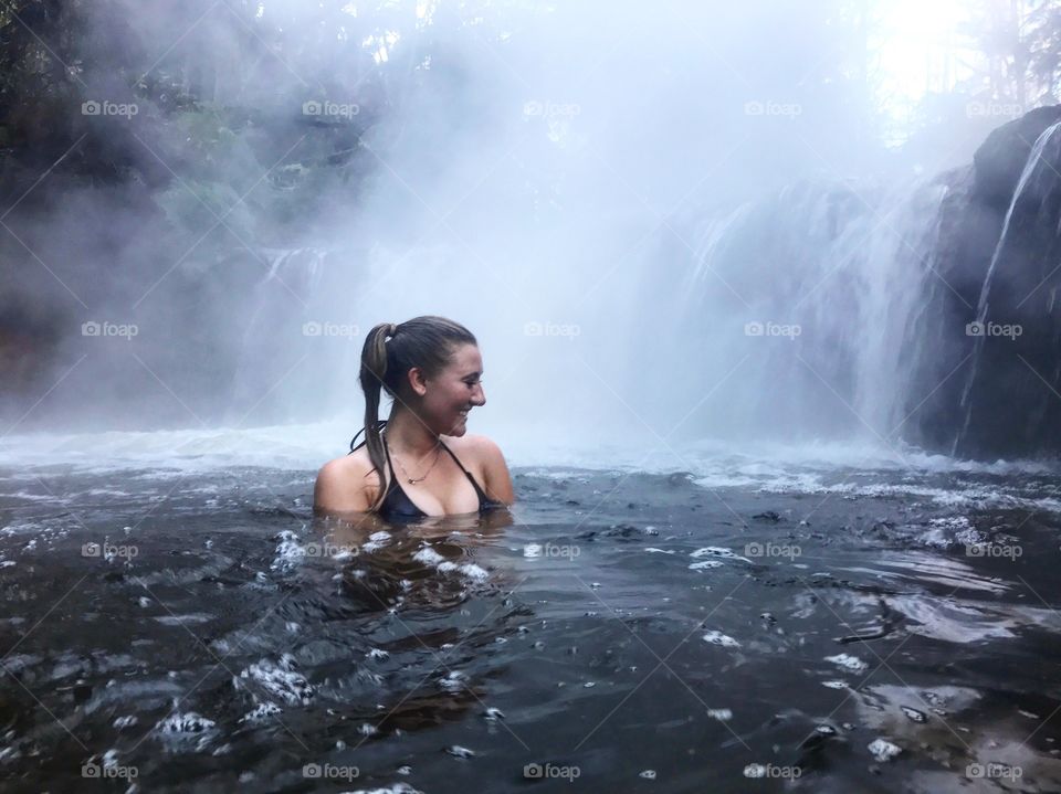 Woman enjoying waterfall