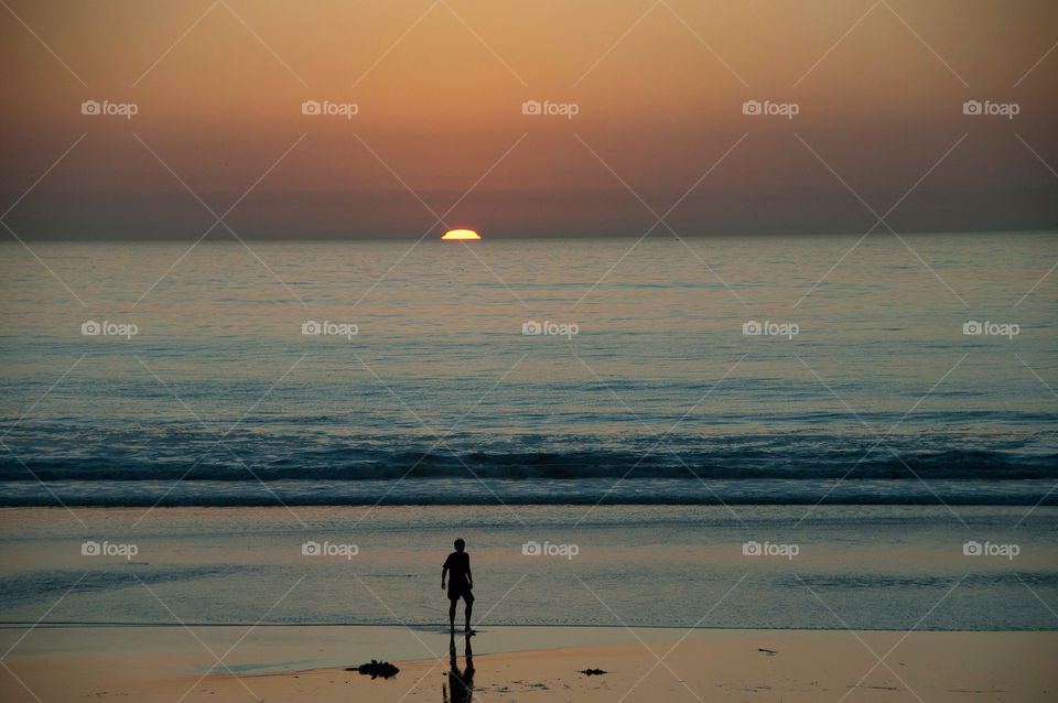 Person playing on the beach at sunset in California
