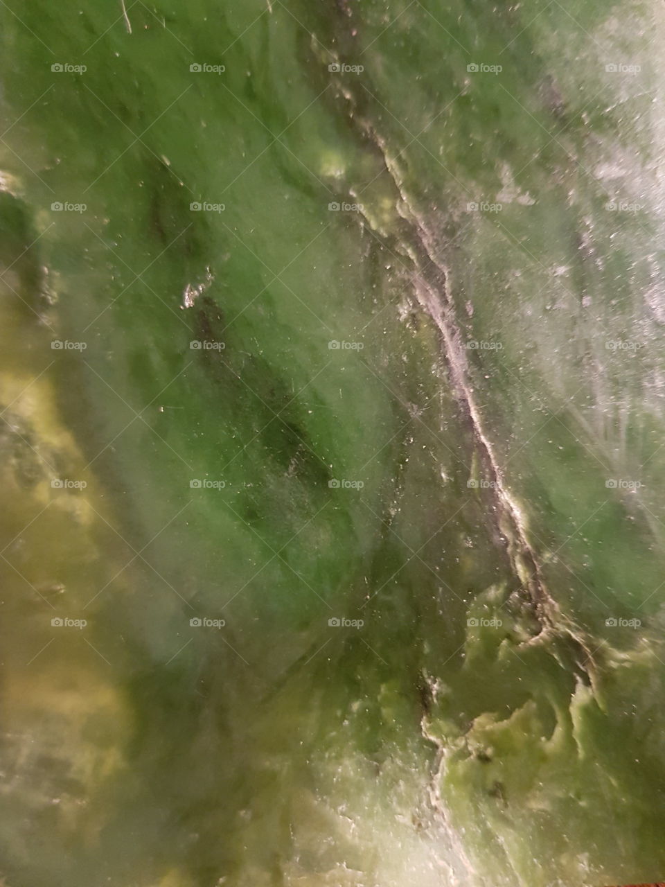 Green stone (paunamu) A type of stone found in the south Island of NZ similar to jade. A close up of a piece. Can be carved into pendants earrings and other jewelry.