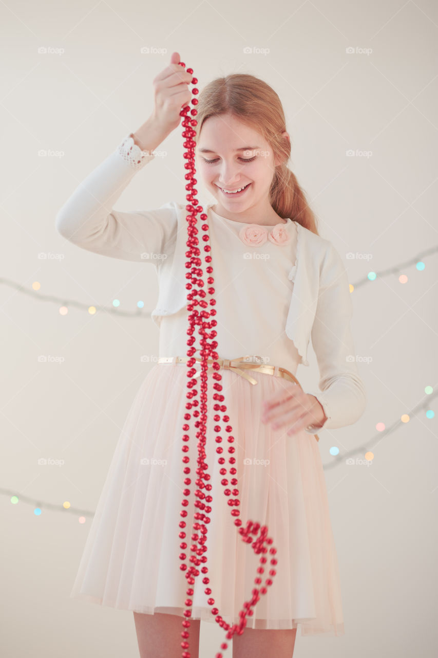 Young woman holding string ornament