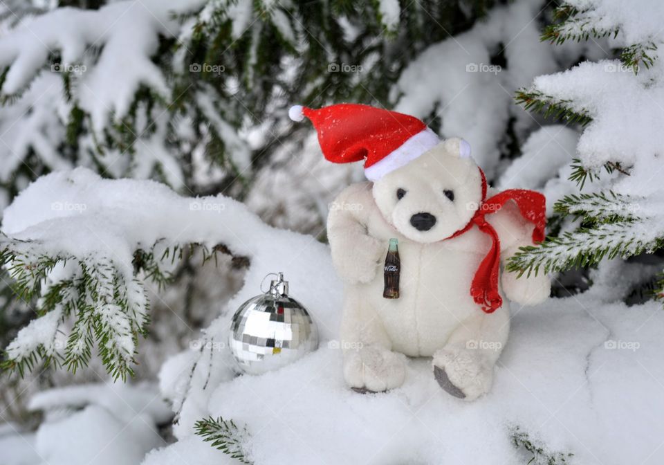 white bear and ball toys on a fir tree in the snow Christmas decorations