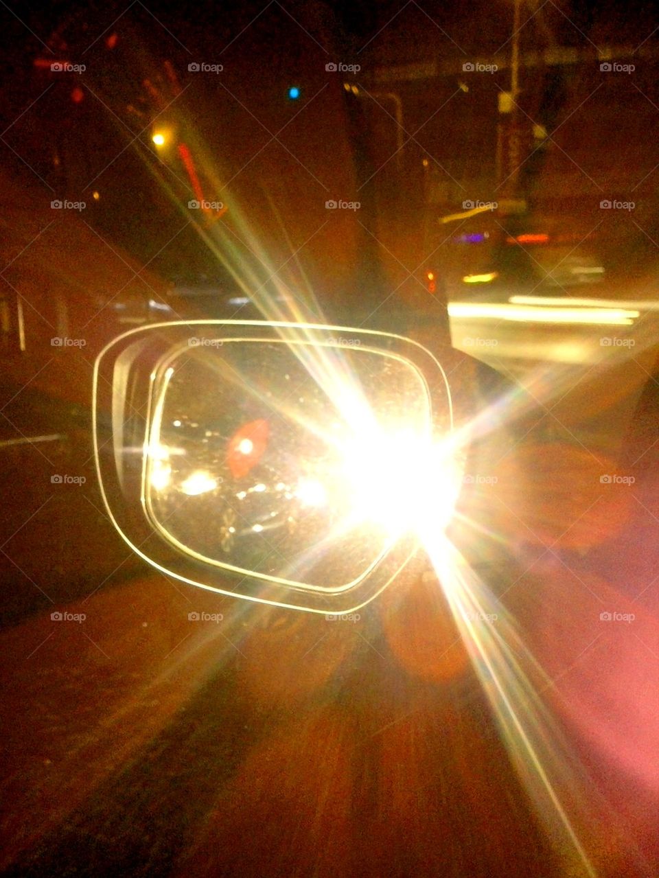 headlight reflection on a car's side mirror