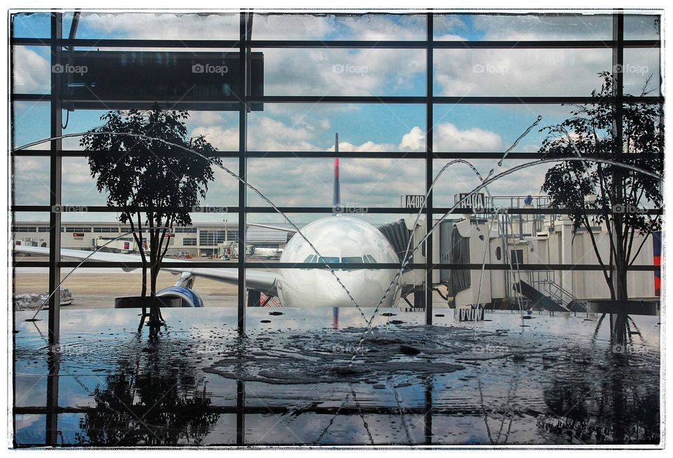 A creative effect of the fountain at Detroit Metroplolitan airport and the Delta airlines Boeing 767