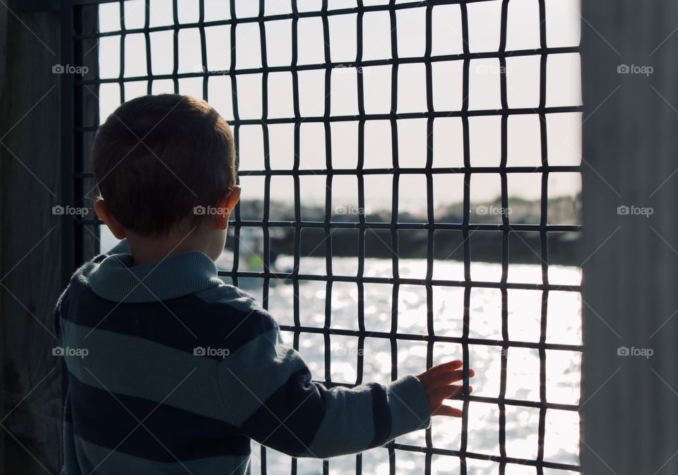 Child looking out at the ocean