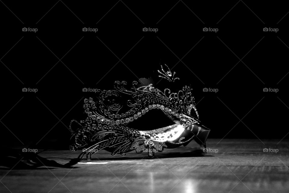 Black and white venetian mask in the dark.