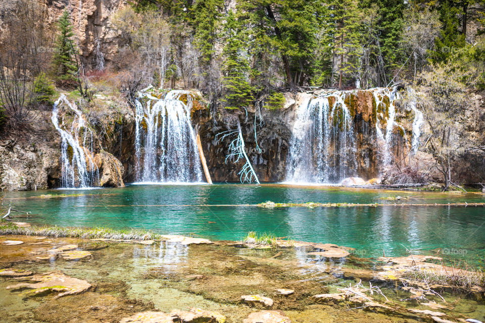 Beautiful crystal clear water flowing from a waterfall into a Colorado lake high in the mountains. 