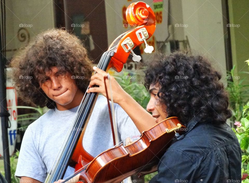 Street Musicians. Virtuoso Musicians Playing Stringed Instruments For The Public On A Mexican City Street
