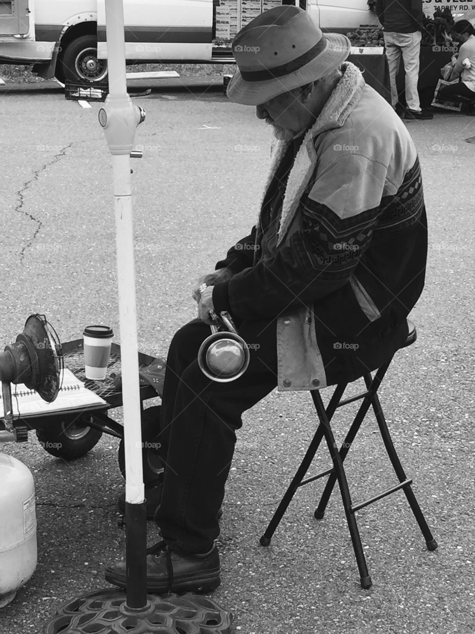 Musician resting at Farmers Market on a Saturday 