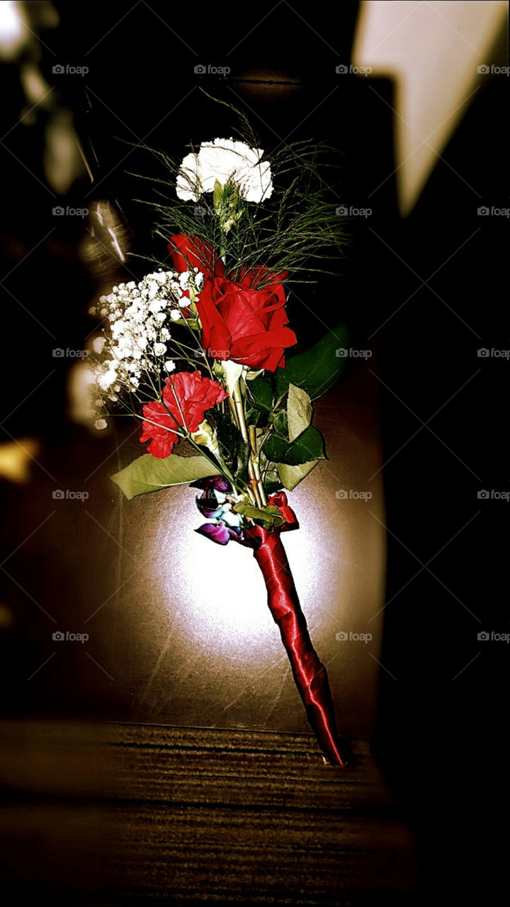 Red Roses and Baby's Breath wrapped with a red ribbon.
