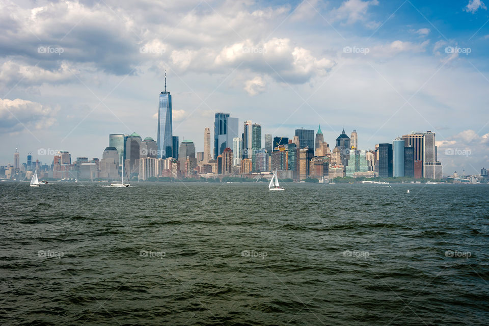Skyline and modern office buildings of Midtown Manhattan viewed from across the Hudson river.