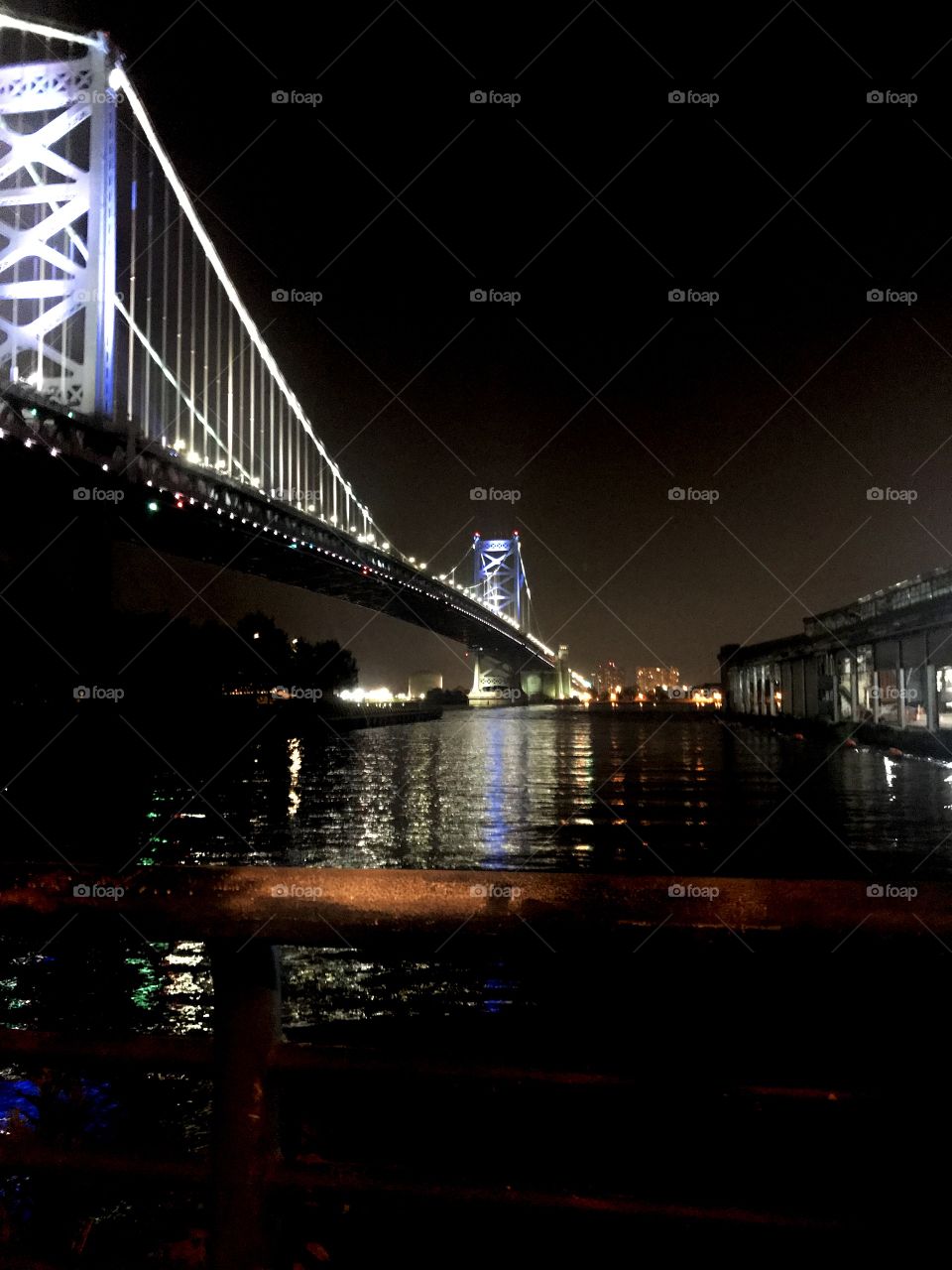 View from festival pier in Philadelphia at night. Bridge over water