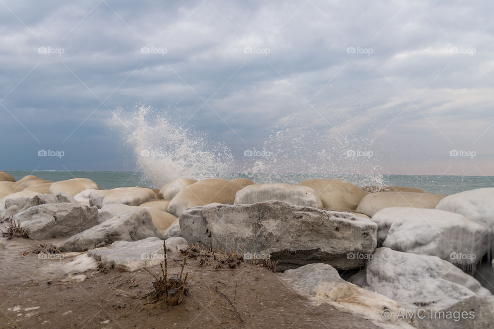 Crashing waves against large rocks on Lake Michigan