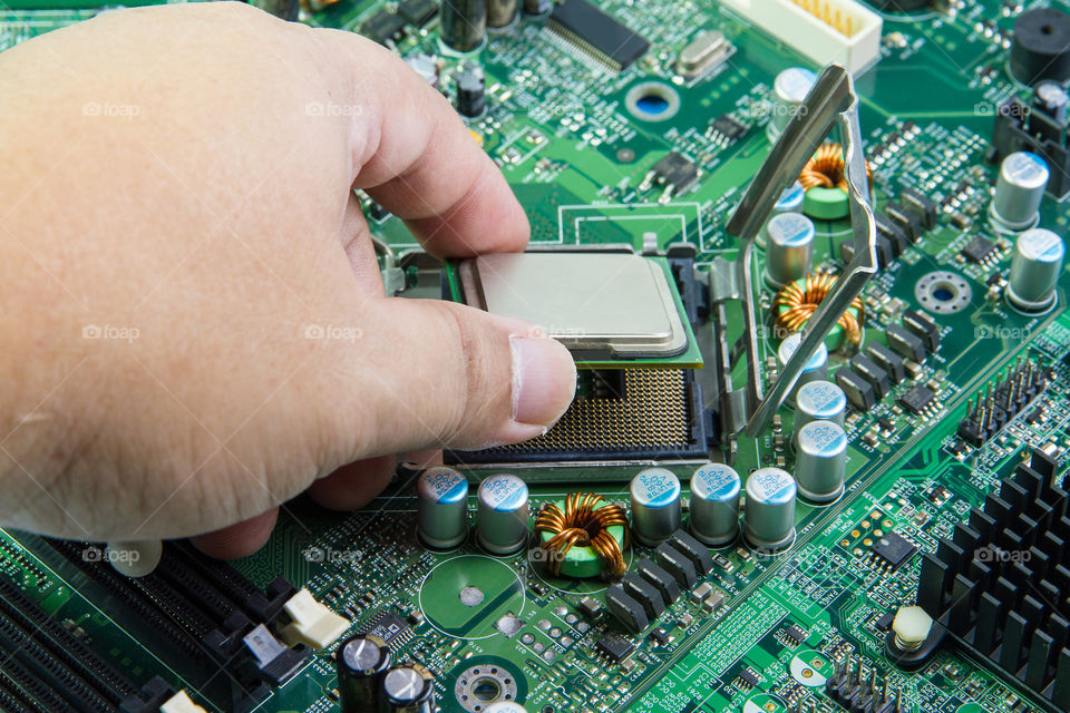 CPU in hand before installation into the motherboard