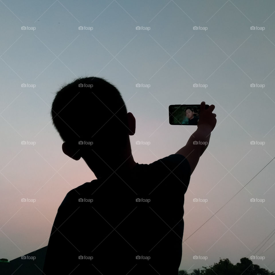 silhouette children take a selfie
