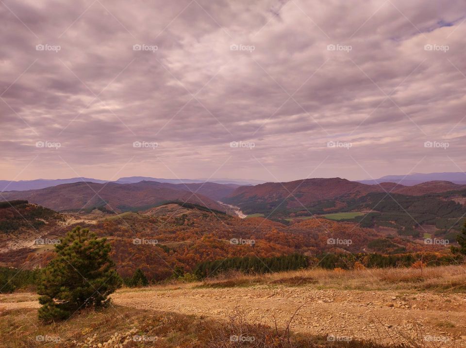 Mountain View form an eco park pathway / road in a valley / beautiful sky over the hills / Amazing nature in the autumn / hills in the fall