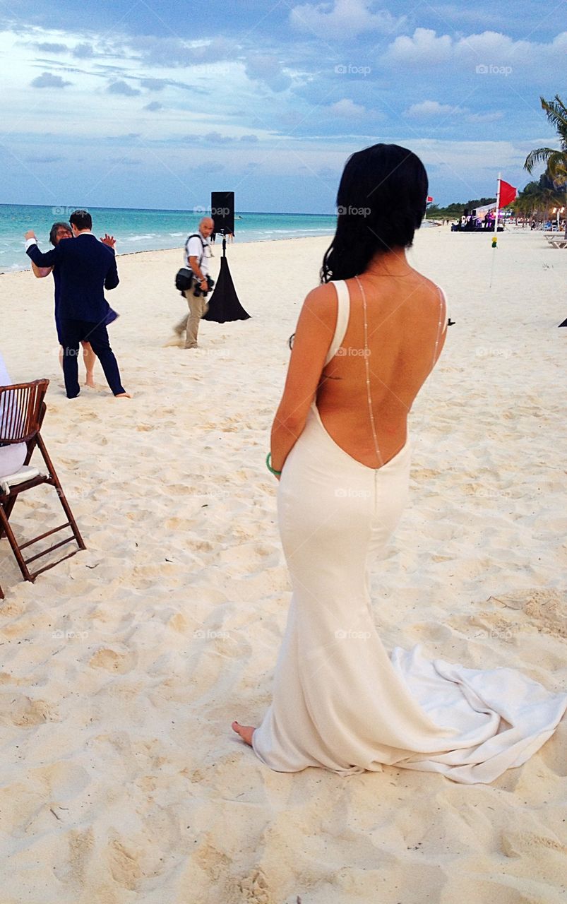 Rear view of woman standing on sandy beach