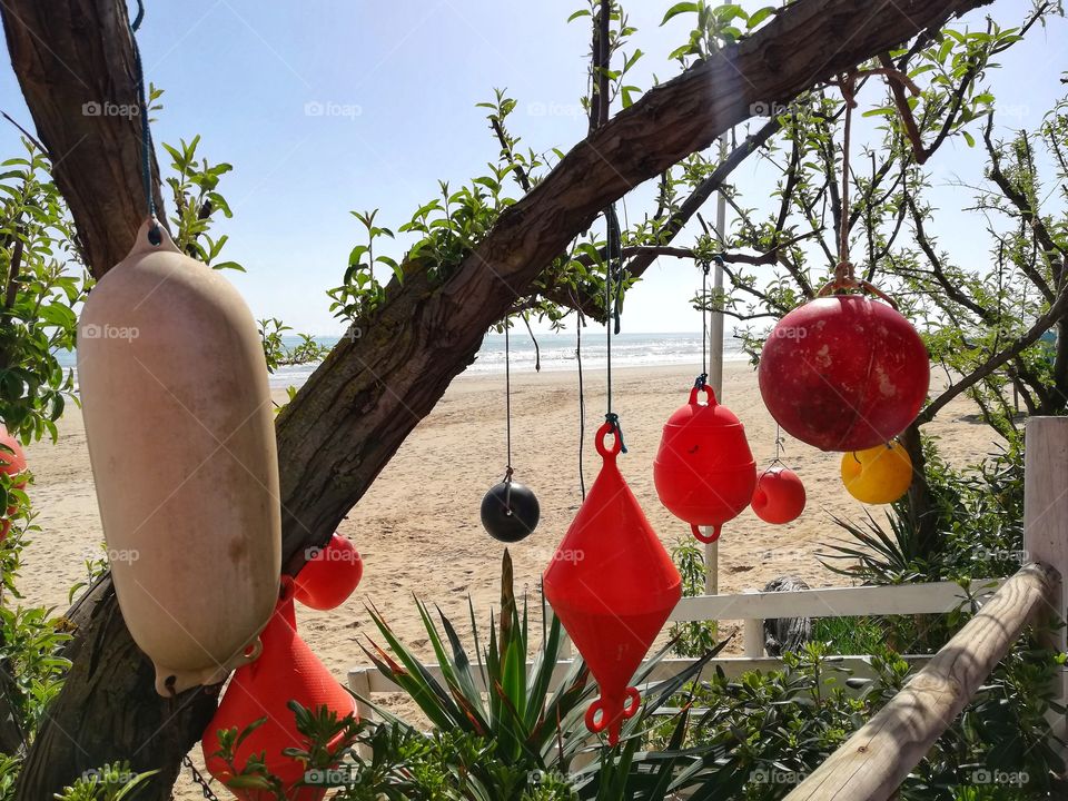 Various colored floats hanging on the tree