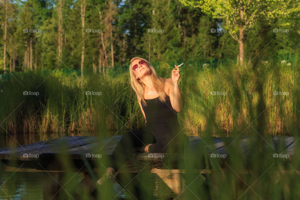 A young woman is taking a cigarette break