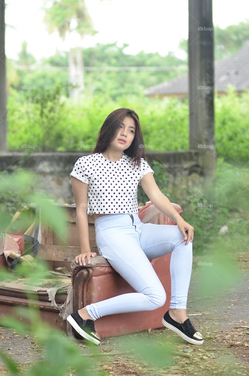 a beautiful girl is posing in casual clothes