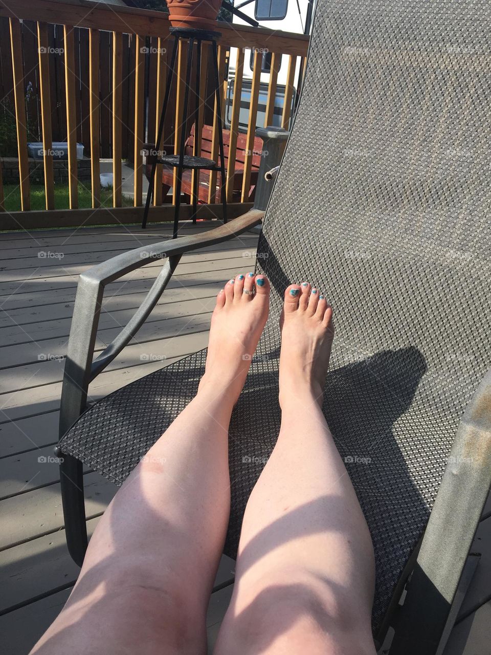 Middle aged white lady trying to tan her legs and feet