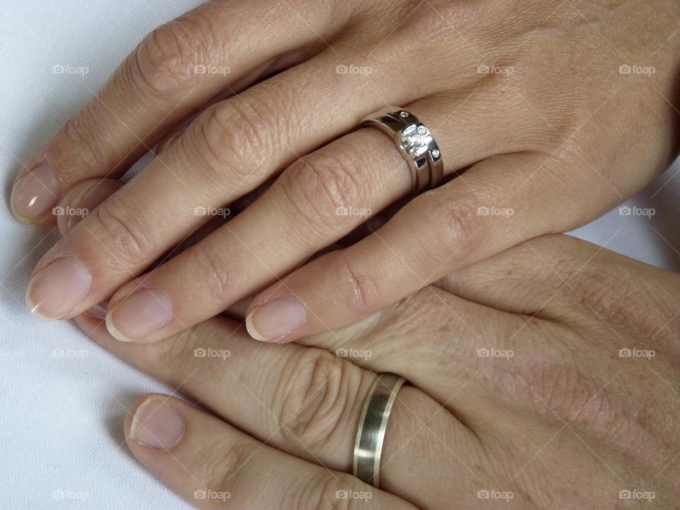 Hands touching showing wedding rings