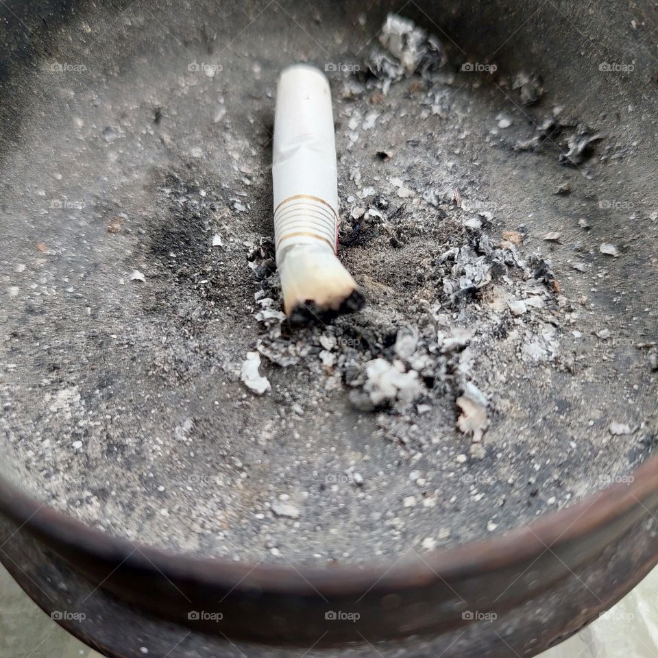 cigarette butts in a wooden ashtray