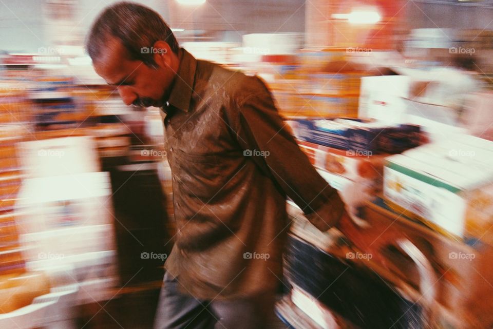 A man pulling his cart in the market