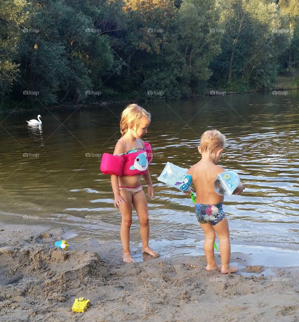 Two kids and a swan