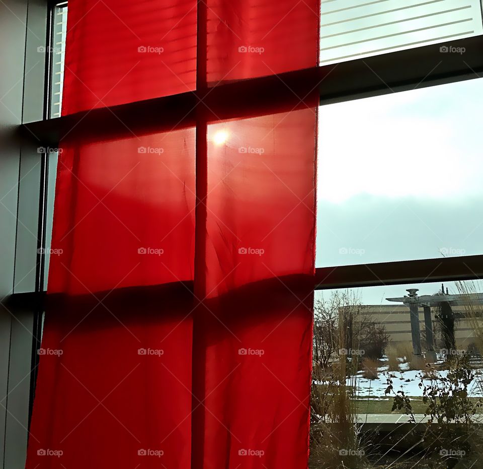 Red curtain near window
